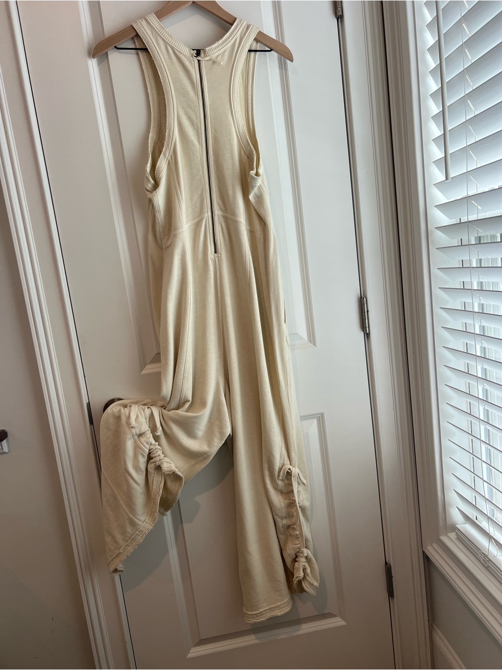 Anthropologie Cream Sleeveless Jumpsuit with Front Zip and Knotted Leg Details